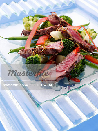 Griddled sirloin steak strips and vegetable salad