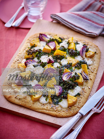 A vegetable pastry with butternut squash, green cabbage and red onions