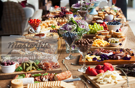 Various party snacks on a wooden table