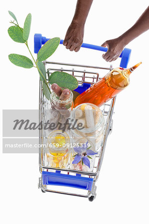 Hands pushing a shopping trolley full of pharmaceutical products