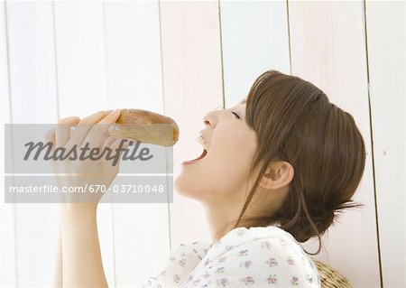 Young woman eating bread Young woman eating bread