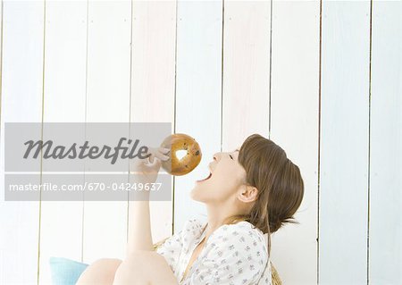Woman eating bagel Woman eating bagel