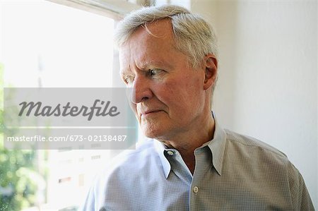 Portrait of a man looking out the window.