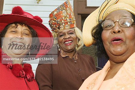 Portrait of three senior women wearing hats.