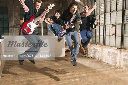 Four young men playing in a band
