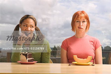 Two women eating different food