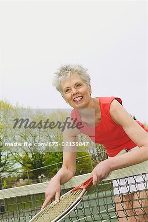 A middle-aged woman playing tennis