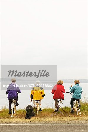 Four women on stationary bikes