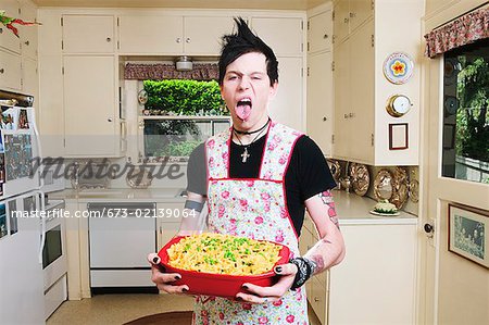 Man in the kitchen holding a casserole
