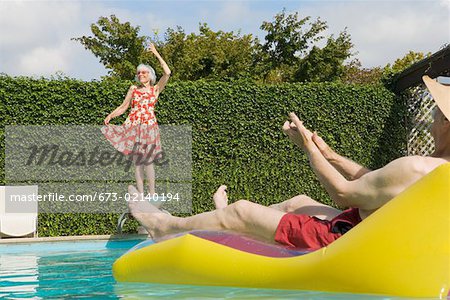 Senior couple having poolside fun