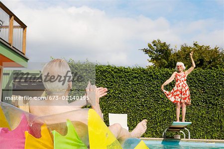 Senior couple having poolside fun