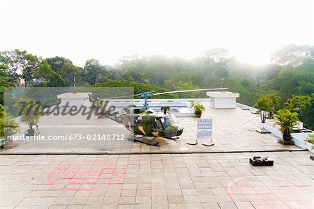 Helicopter on terrace surrounded by jungle