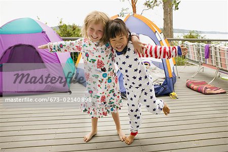 Girls in pajamas with tents on balcony