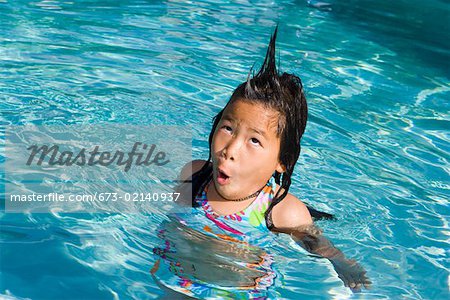 Closeup of girl in pool with silly hairdo