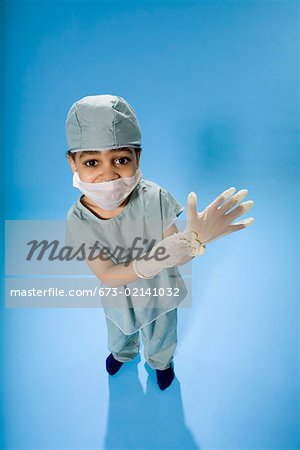 High angle portrait of young boy dressed in scrubs