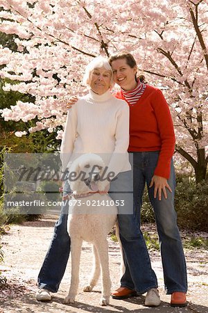 Portrait of mother with grown daughter and dog