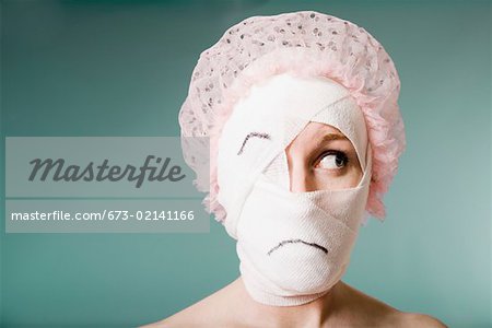 Sad woman with head wrapped in bandage