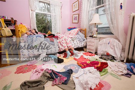 Free Photo  Messy bedroom with clothes on bed high angle