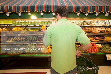 Man selecting produce in supermarket