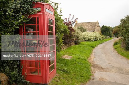 Red telephone booth in rural community