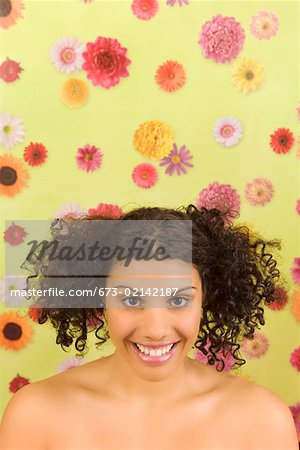 Portrait of woman in front of flower background