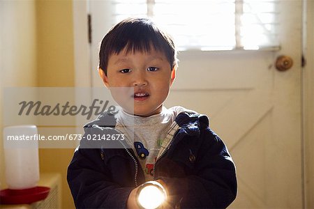 Young boy using a flashlight