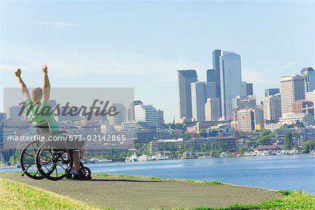 Man in wheelchair looking at city skyline