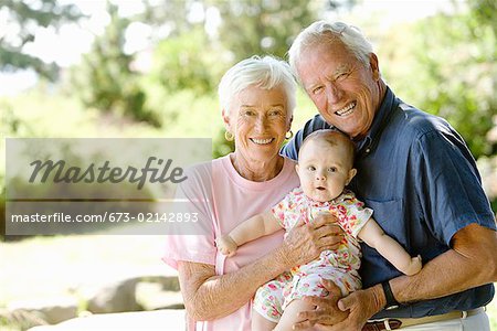 Senior couple holding baby