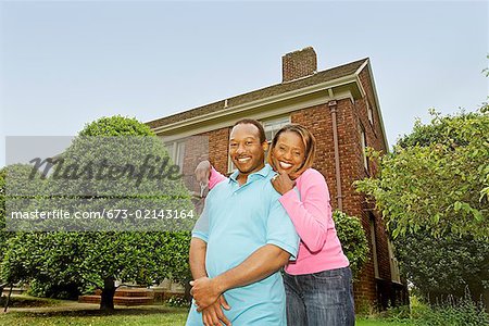 African couple in front of new house