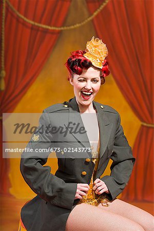 Woman wearing military jacket and winking