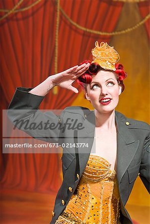 Woman wearing military jacket and saluting