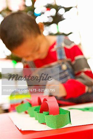 Asian boy making paper chain