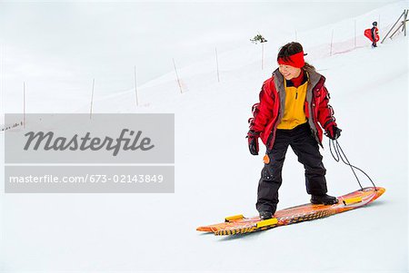 Asian girl riding on sled