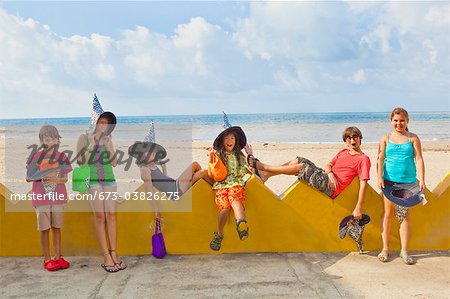 children at beach in witch hats