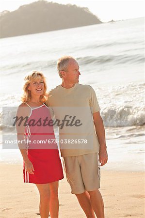 middle aged couple hugging on beach