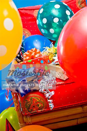 red chair with gifts and balloons