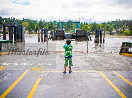 Boy standing on car deck of ferry