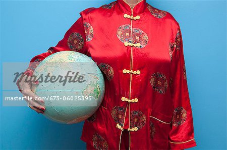 Woman in Chinese pajamas holding globe