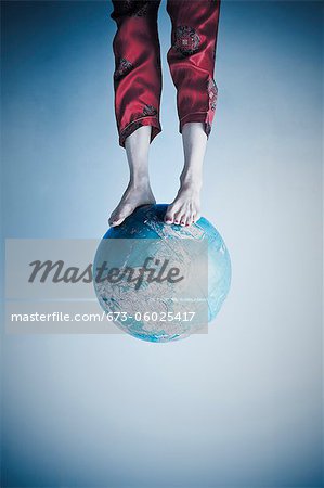 Feet and legs on globe