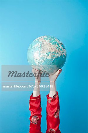 Feet holding globe
