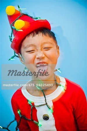 Boy in red costume with holiday lights