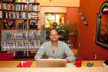 Smiling man seated at desk in home office