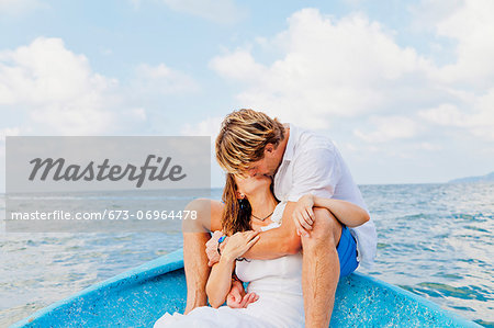 Man and woman embracing in bow of boat