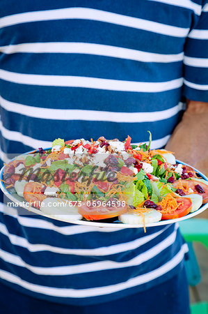 Man holding platter of mexican food