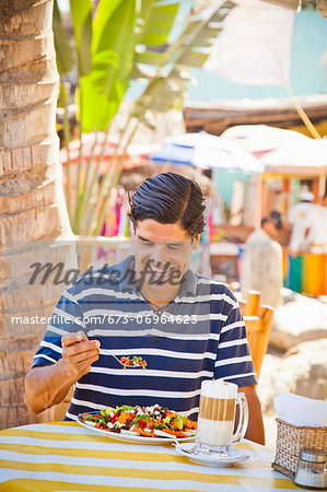 Man eating at outdoor caf