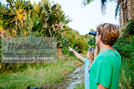 Couple birdwatching in jungle