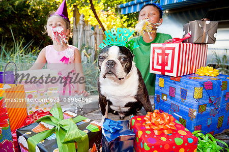 Two children and dog at outdoor birthday party