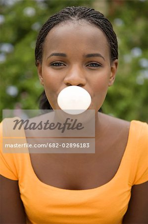 South African Teen Culture Portrait Of A Young Woman Blowing A Bubble Stock Photo Masterfile Premium Royalty Free Code 6 0261