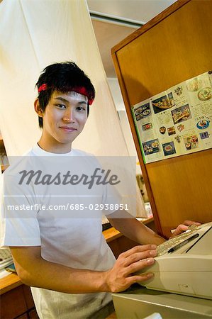 Young man working on cash register