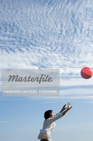 Young man playing with beach ball